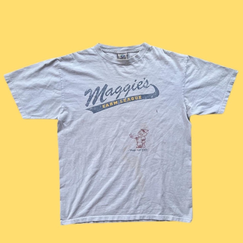 Liquid blue T-shirt has stains but no tears or holes.